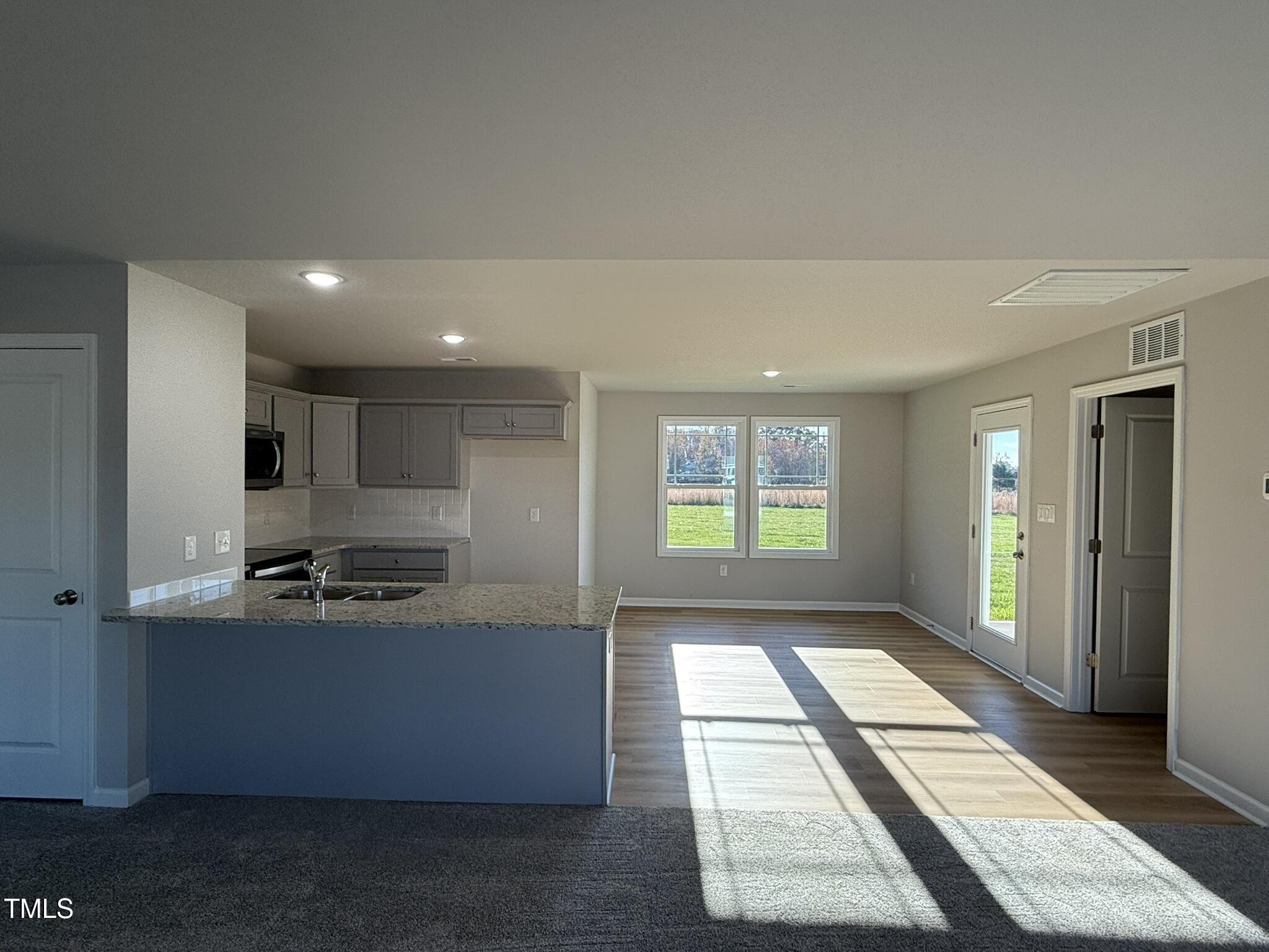 198 Pate Landing Drive Selma, NC 27576 - Photo 6 of 16 a kitchen with stainless steel appliances granite countertop a sink and a stove