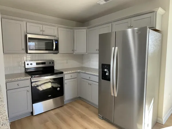a kitchen with a refrigerator stove and microwave