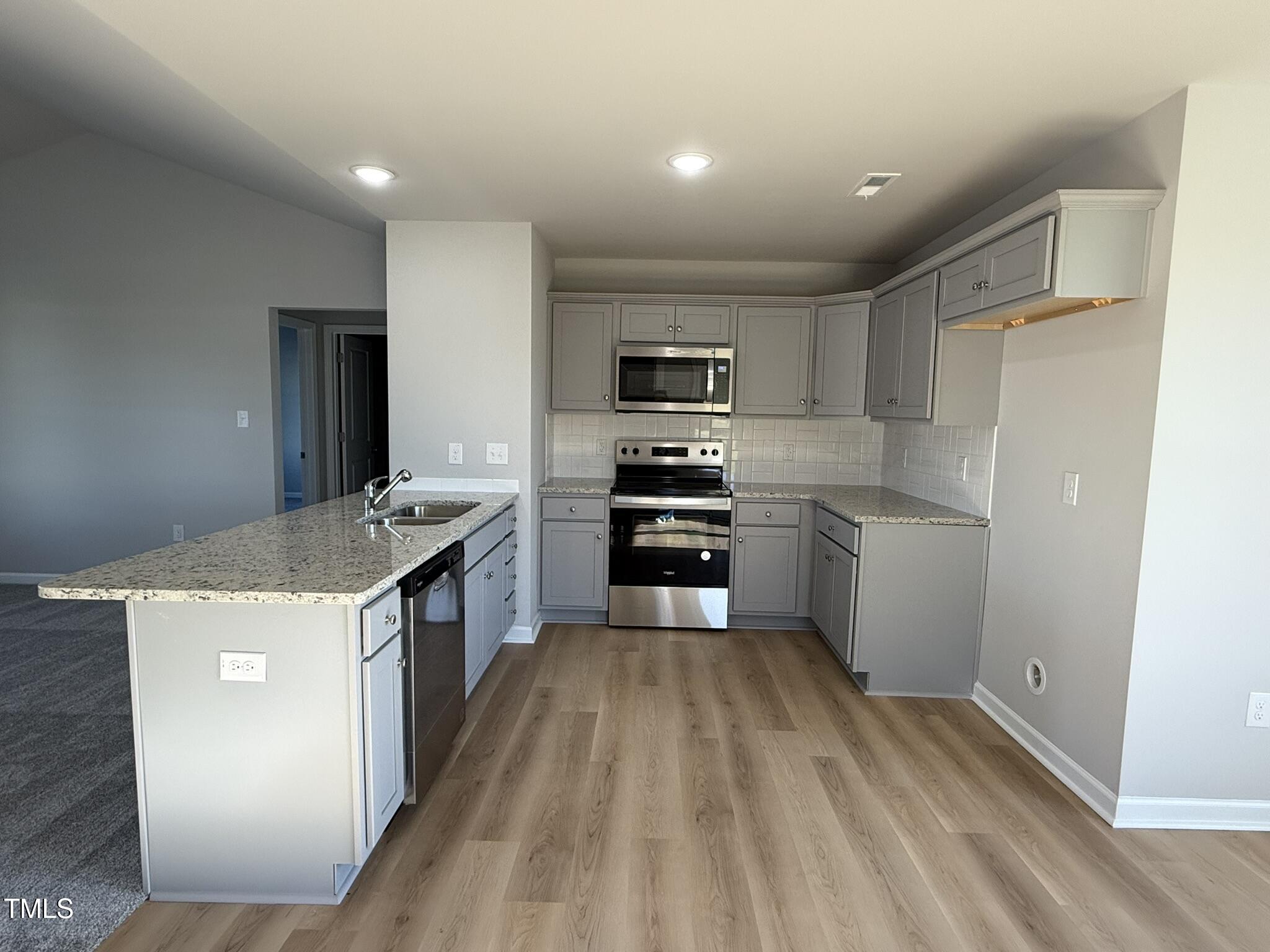 198 Pate Landing Drive Selma, NC 27576 - Photo 7 of 16 a kitchen with a stove a sink and a refrigerator