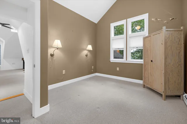 an empty room with windows and entrance