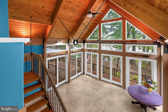 a view of a porch with a table and chairs