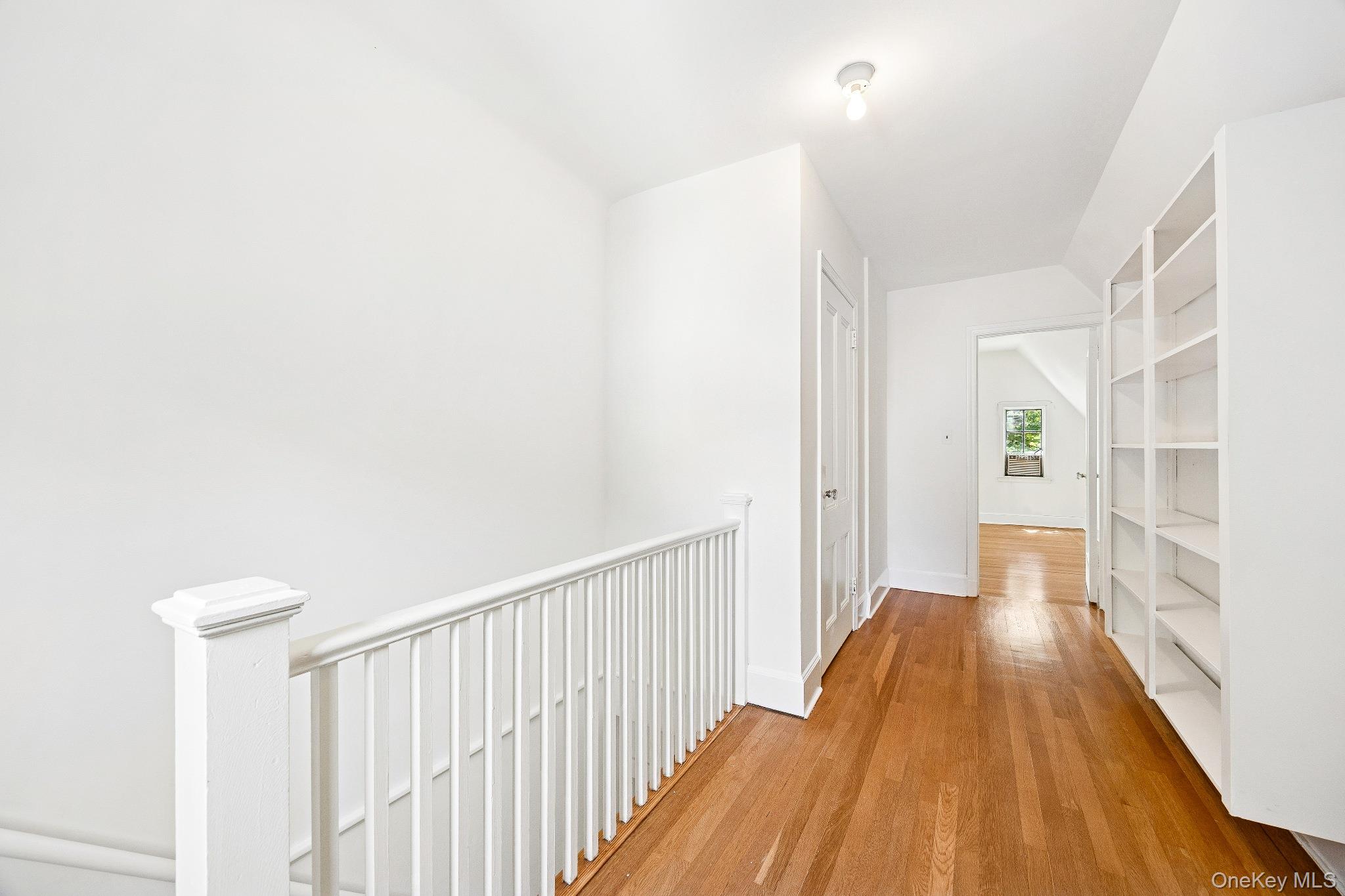 10 River Road Scarsdale, NY 10583 - Photo 18 of 20 Hallway with an upstairs landing, light wood-style floors, and lofted ceiling