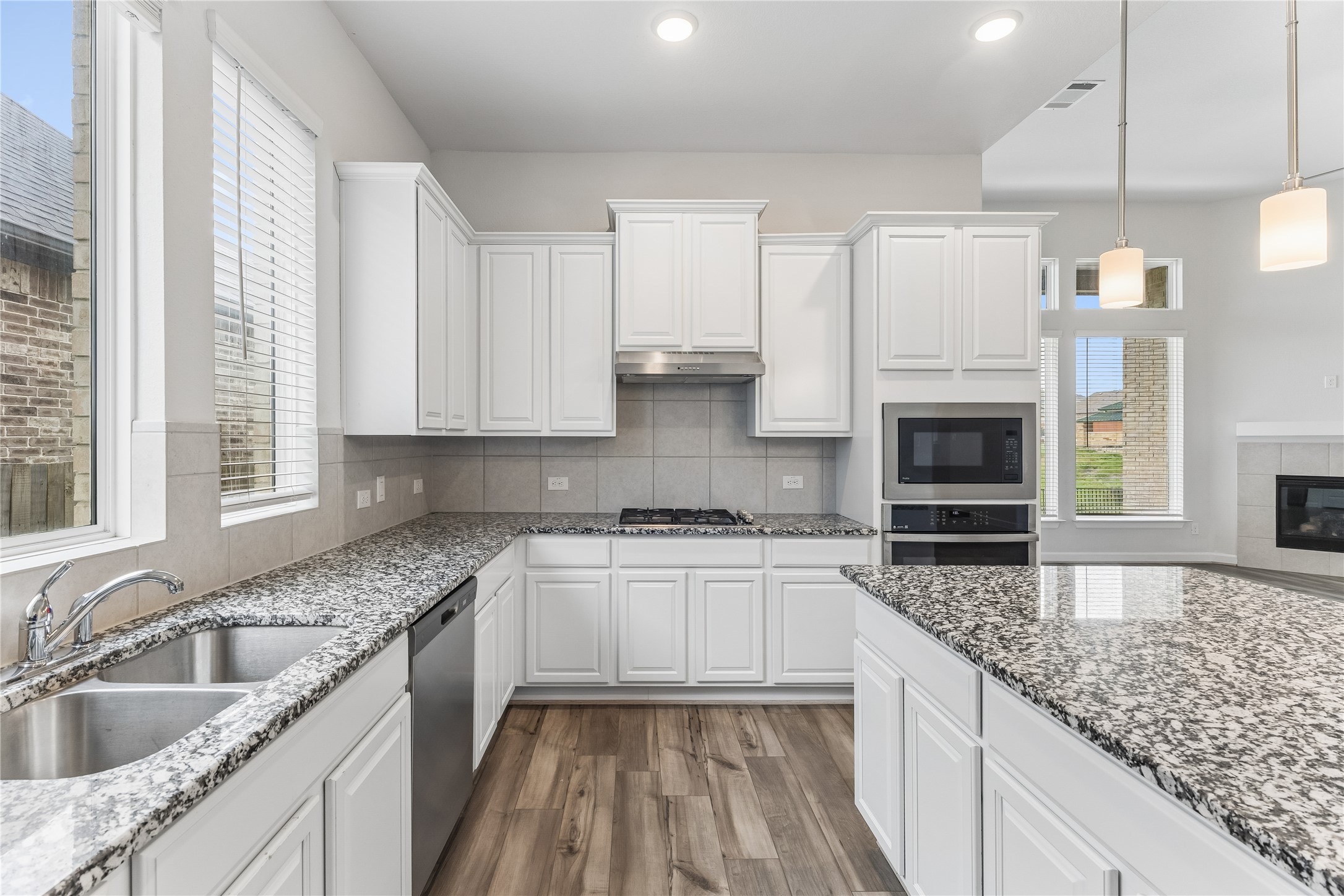298 Wild Pecan Loop Buda, TX 78610 - Photo 11 of 40 a kitchen with stainless steel appliances granite countertop a sink stove and cabinets