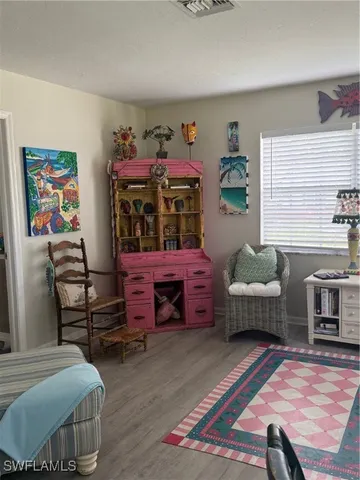 a bedroom with furniture and a baby crib