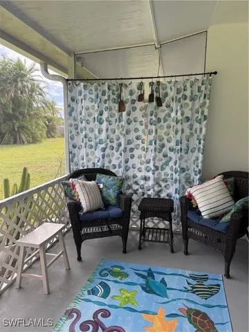 a living room with furniture and a floor to ceiling window