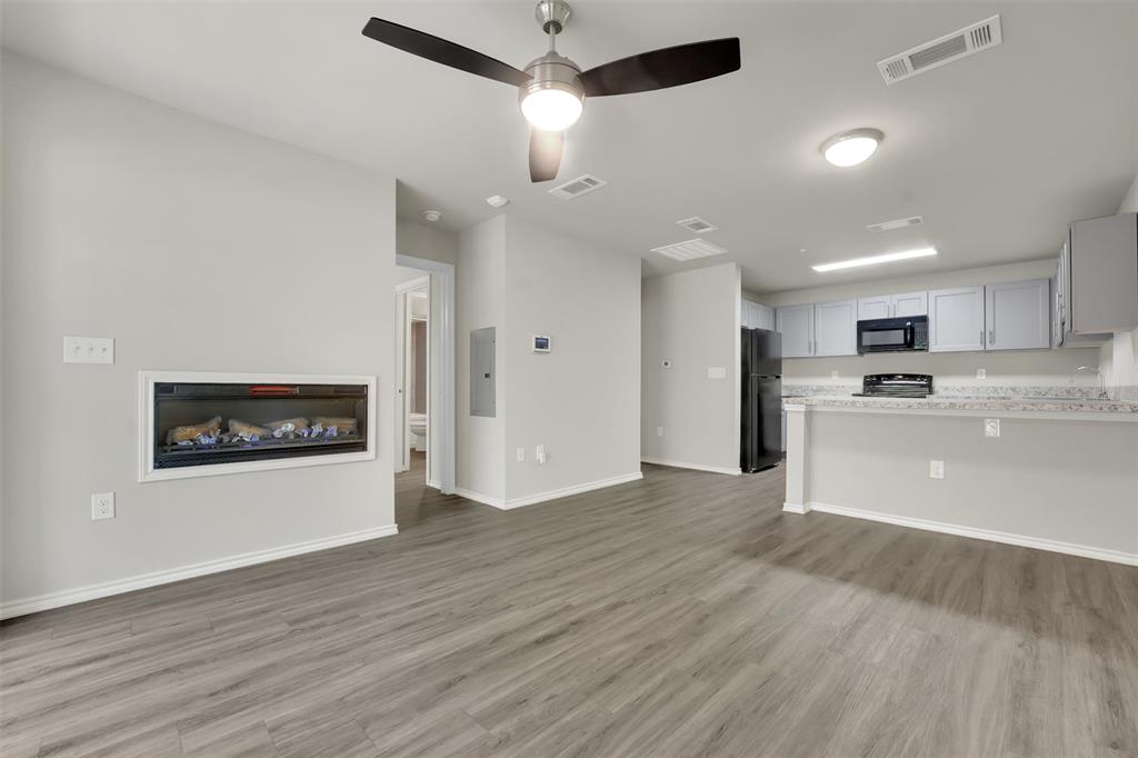 6108 Abrams Road, Unit 211 Dallas, TX 75231 - Photo 2 of 18 a view of kitchen with stainless steel appliances refrigerator stove microwave and cabinets