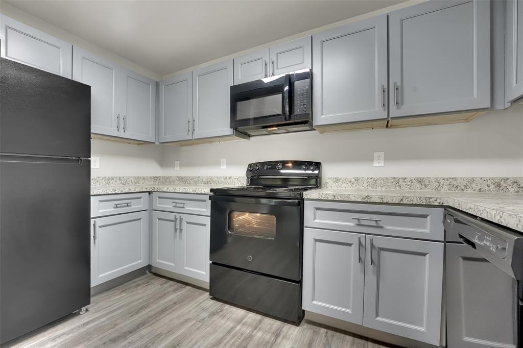 6108 Abrams Road, Unit 211 Dallas, TX 75231 - Photo 3 of 18 a kitchen with white cabinets and stainless steel appliances