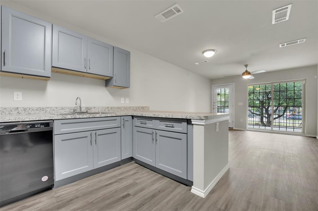 6108 Abrams Road, Unit 211 Dallas, TX 75231 - Photo 4 of 18 a kitchen with granite countertop stainless steel appliances sink and cabinets