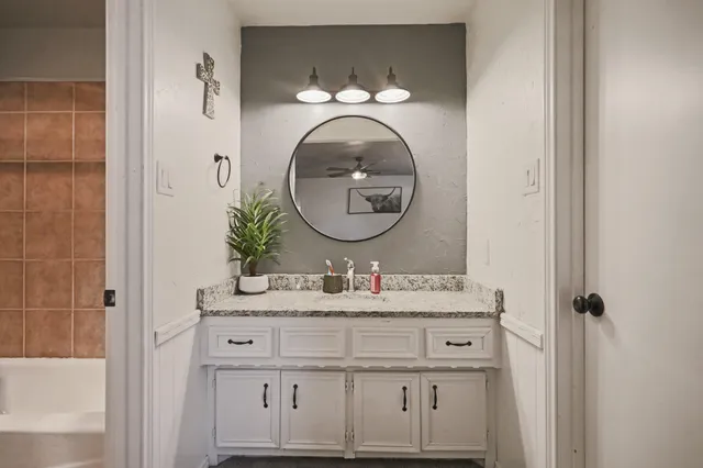 a bathroom with a sink and a mirror
