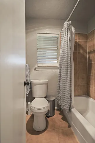 a bathroom with a toilet and a bathtub
