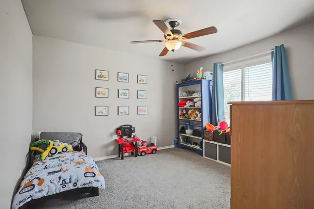 a bedroom with baby bed toys and a window
