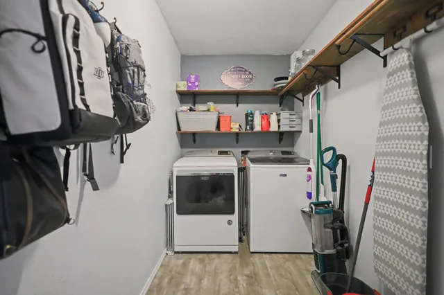 a living room with furniture and a baby crib