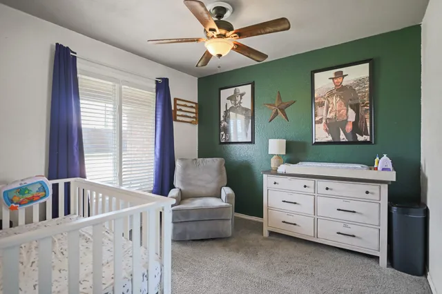 a view of a bedroom with furniture and windows