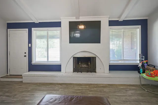 a living room with a fireplace furniture and a window
