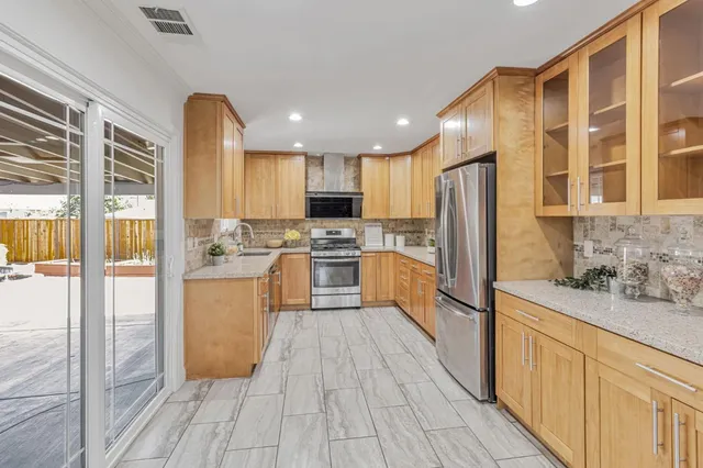 a kitchen with stainless steel appliances a refrigerator sink and cabinets