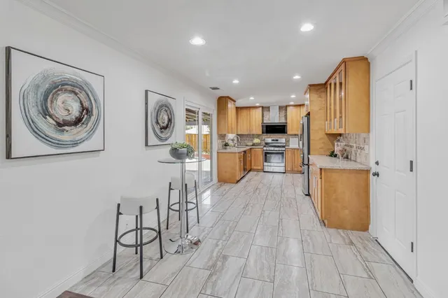 a view of a kitchen with furniture and wooden floor