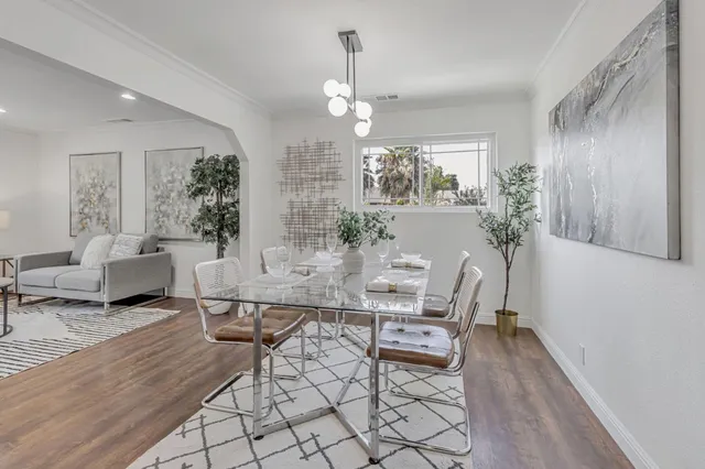 a view of a dining room with furniture window and wooden floor