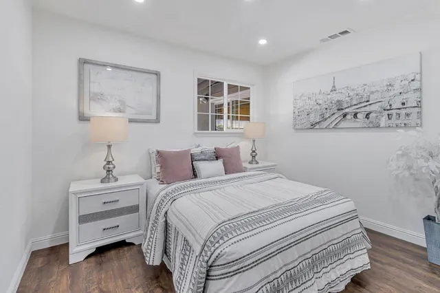 a bedroom with a bed and a night stand