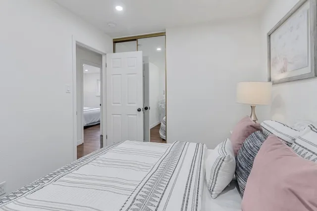 a bedroom with a bed and a lamp