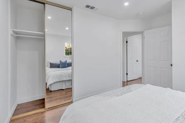 a bedroom with a bed and a mirror