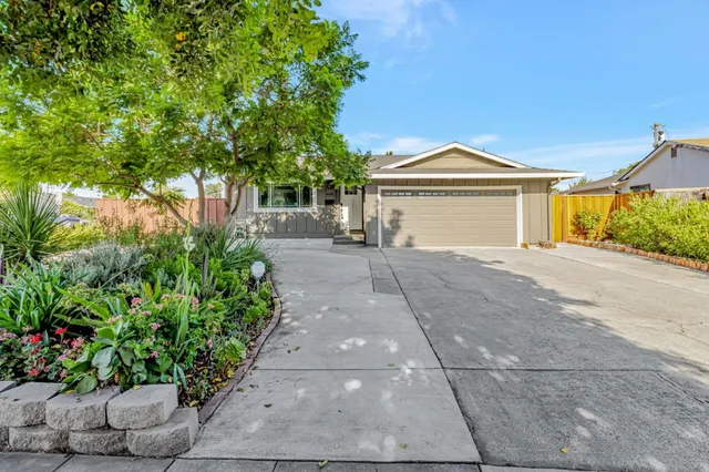 a front view of a house with a garden