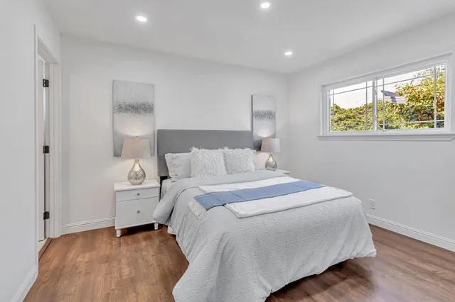 a bedroom with bed and a window