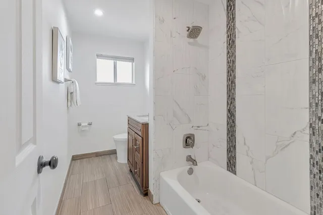 a bathroom with a bathtub and shower