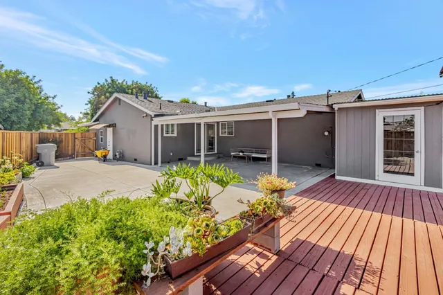 a backyard of a house with table and chairs