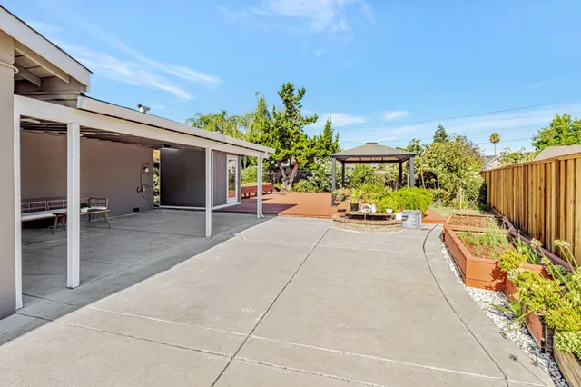 a view of a chairs and table on the wooden deck