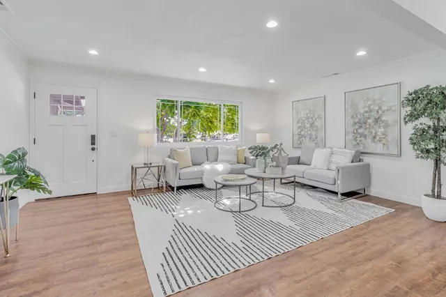 a living room with furniture and a large window