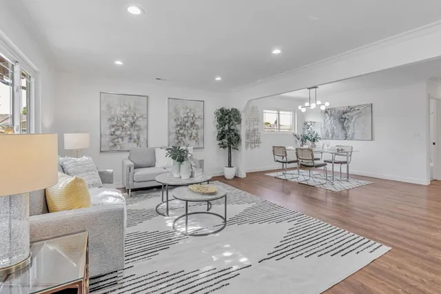 a living room with furniture and a dining table with kitchen view