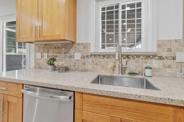 a kitchen with granite countertop a sink and a window