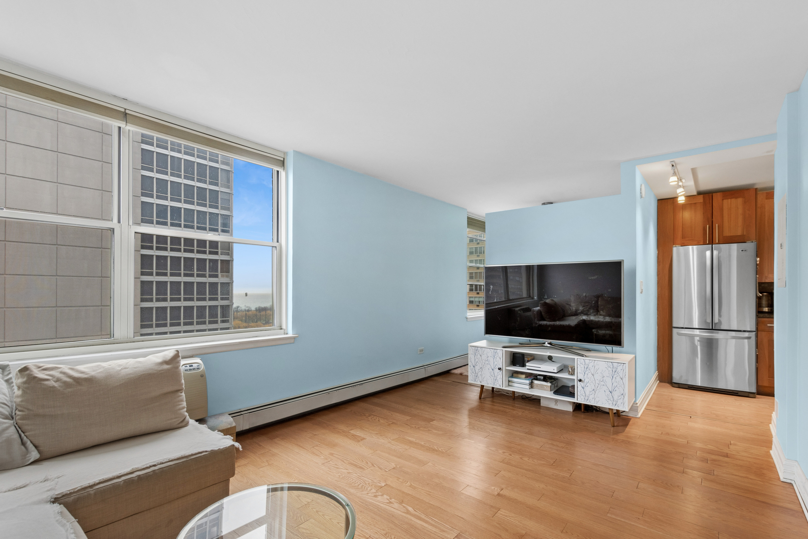 3033 North Sheridan Road, Unit 1502 Chicago, IL 60657 - Photo 2 of 19 a living room with furniture and flat screen tv