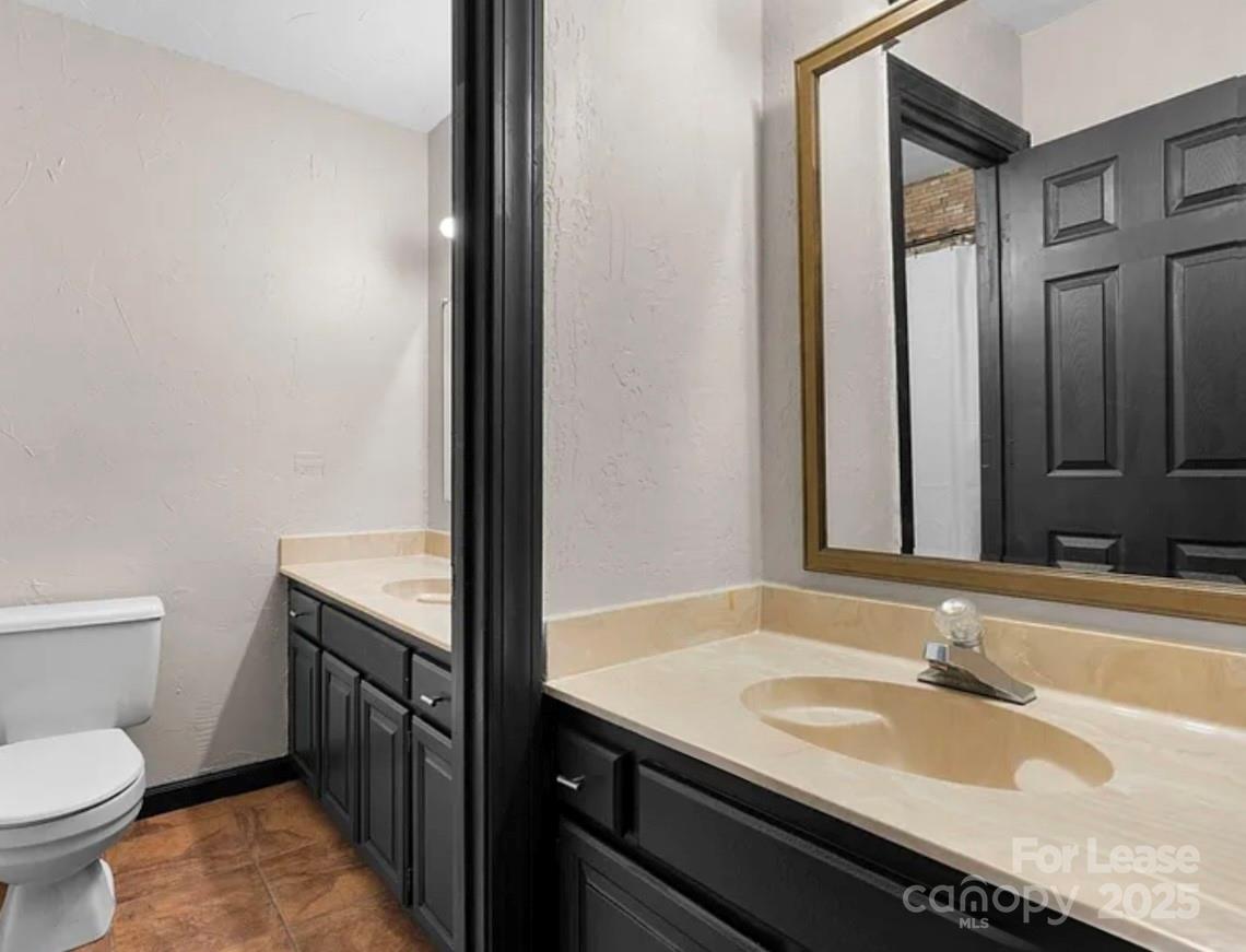 2705 North Center Street, Unit 78 Hickory, NC 28601 - Photo 14 of 17 a bathroom with a granite countertop sink and a toilet