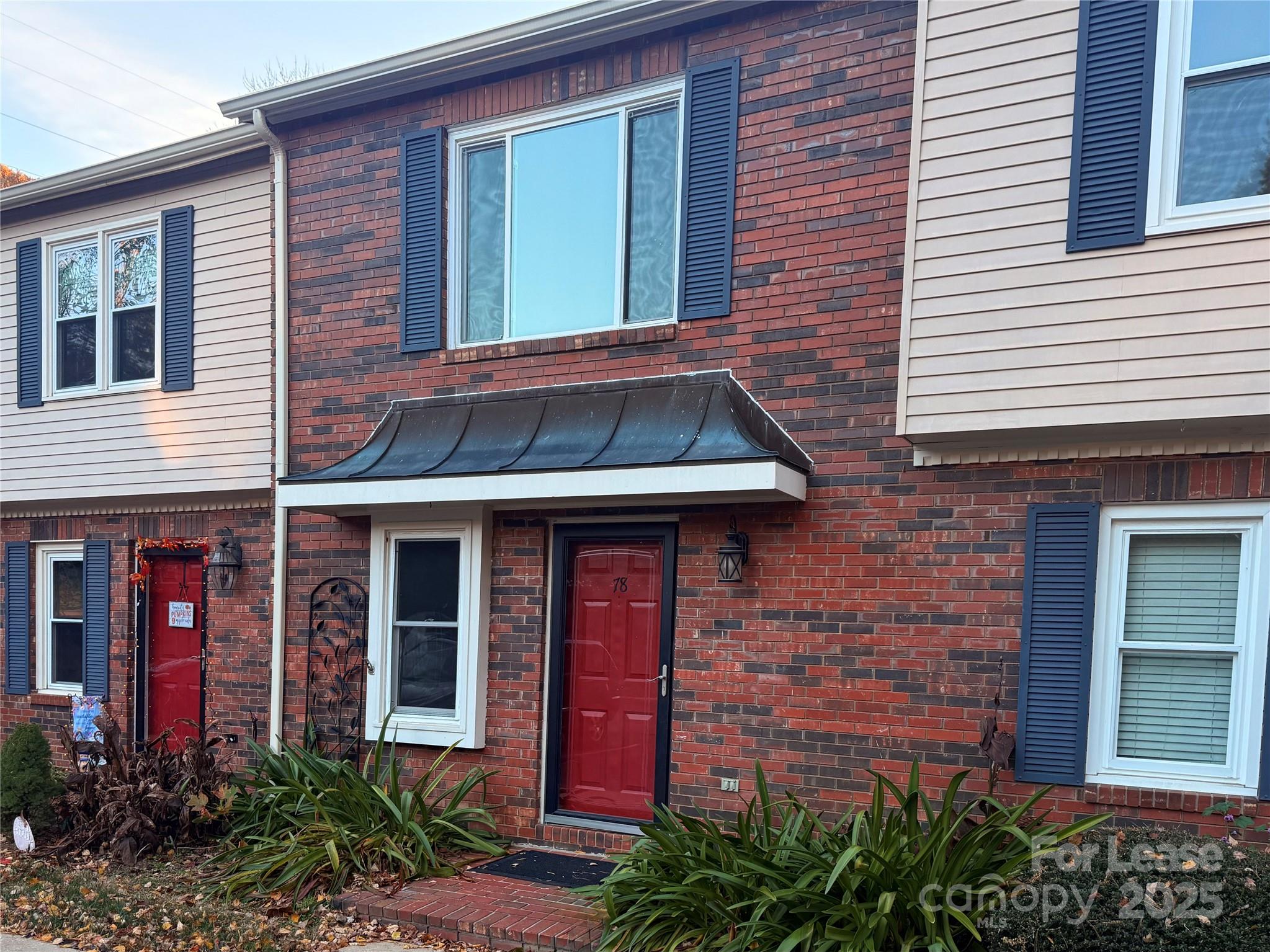 2705 North Center Street, Unit 78 Hickory, NC 28601 - Photo 16 of 17 a view of a brick house with large windows and plants