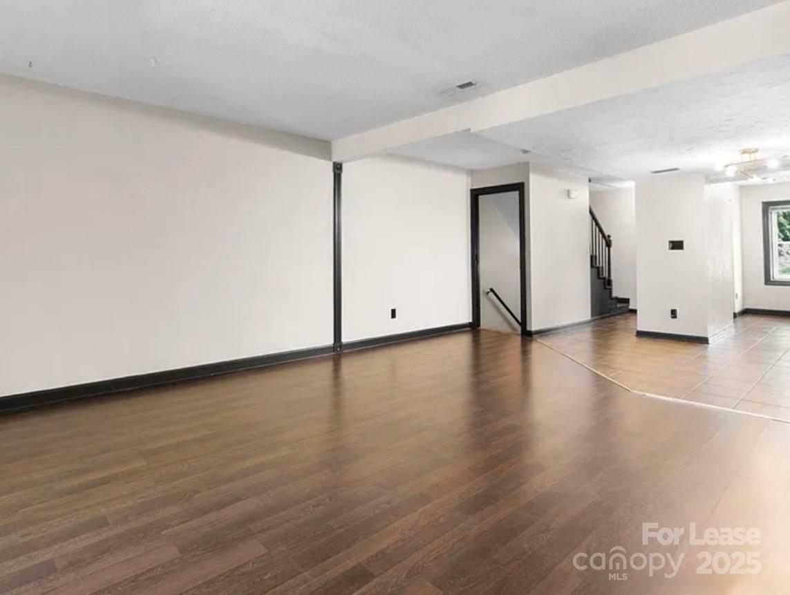 2705 North Center Street, Unit 78 Hickory, NC 28601 - Photo 9 of 17 a view of an empty room with wooden floor and a window