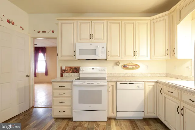 a kitchen with cabinets appliances and a window
