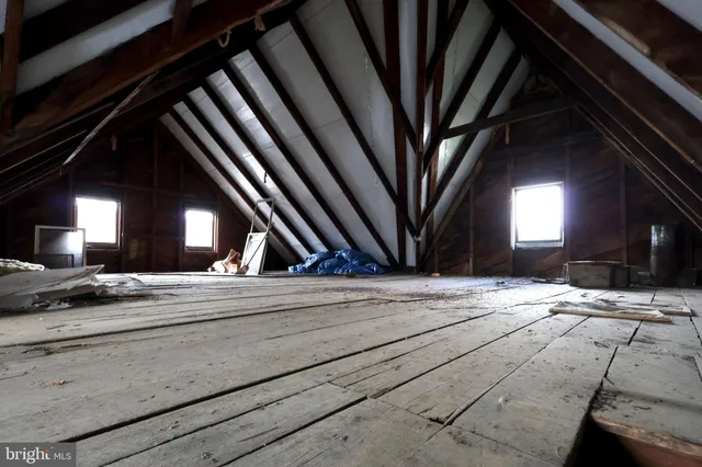 a view of a room with wooden floor and windows