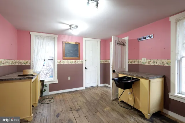 a view of an empty room and kitchen