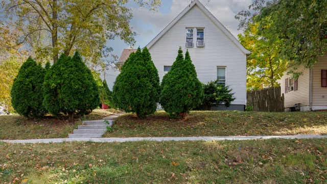 a backyard of a house with plants and trees