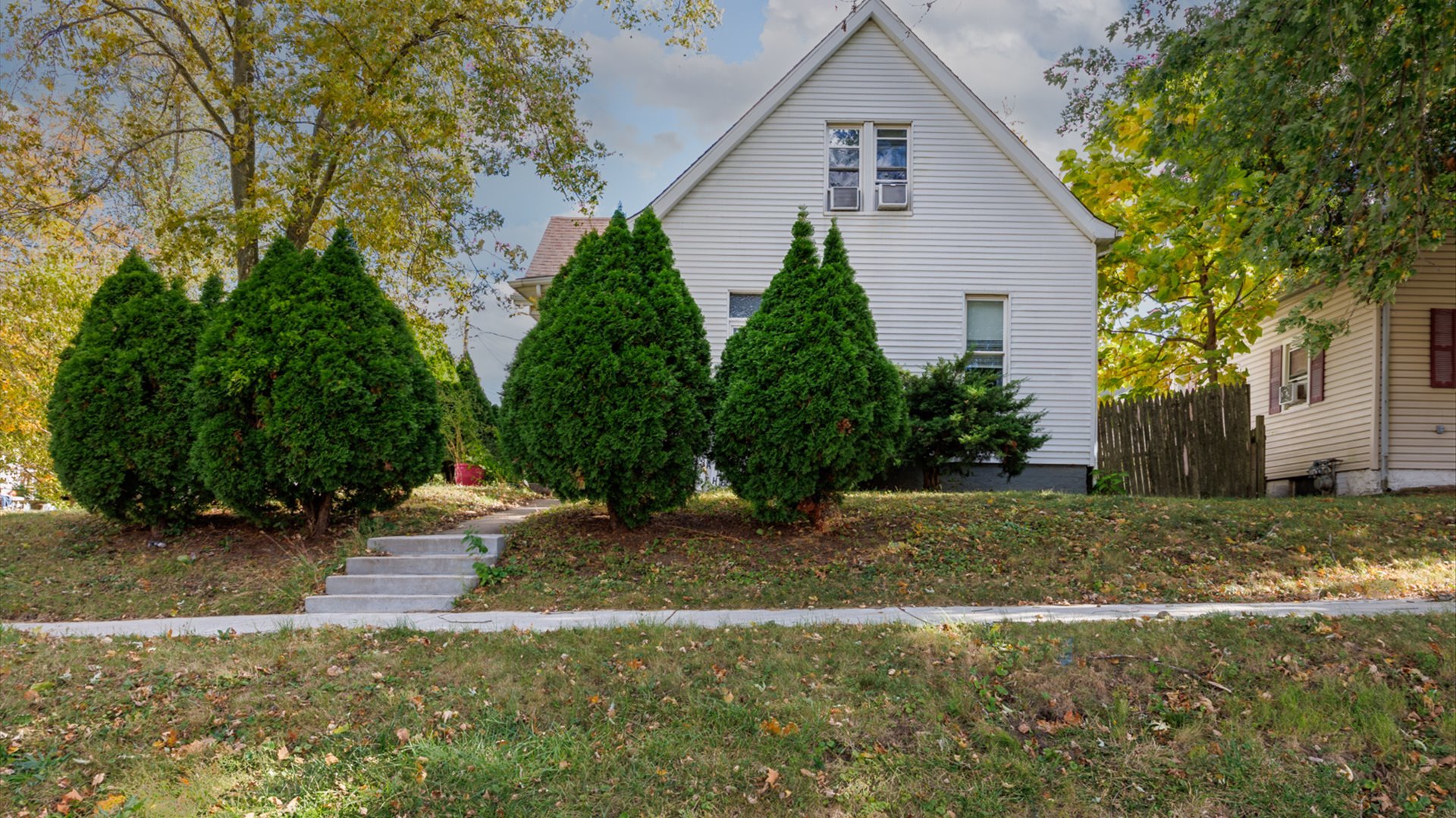 a backyard of a house with plants and trees