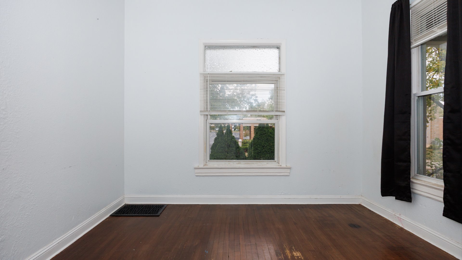 802 South Madison Street Bloomington, IL 61701 - Photo 12 of 33 an empty room with wooden floor and windows