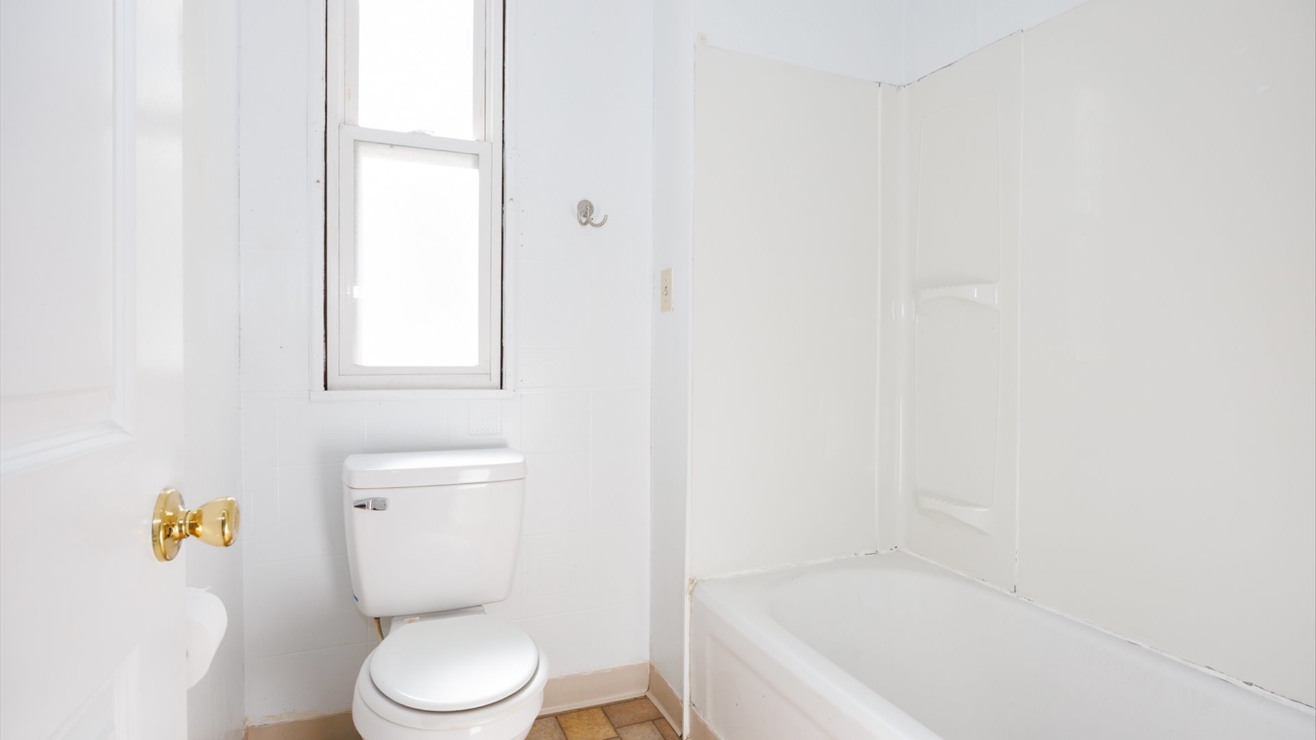 802 South Madison Street Bloomington, IL 61701 - Photo 16 of 33 a white toilet sitting next to a bath tub