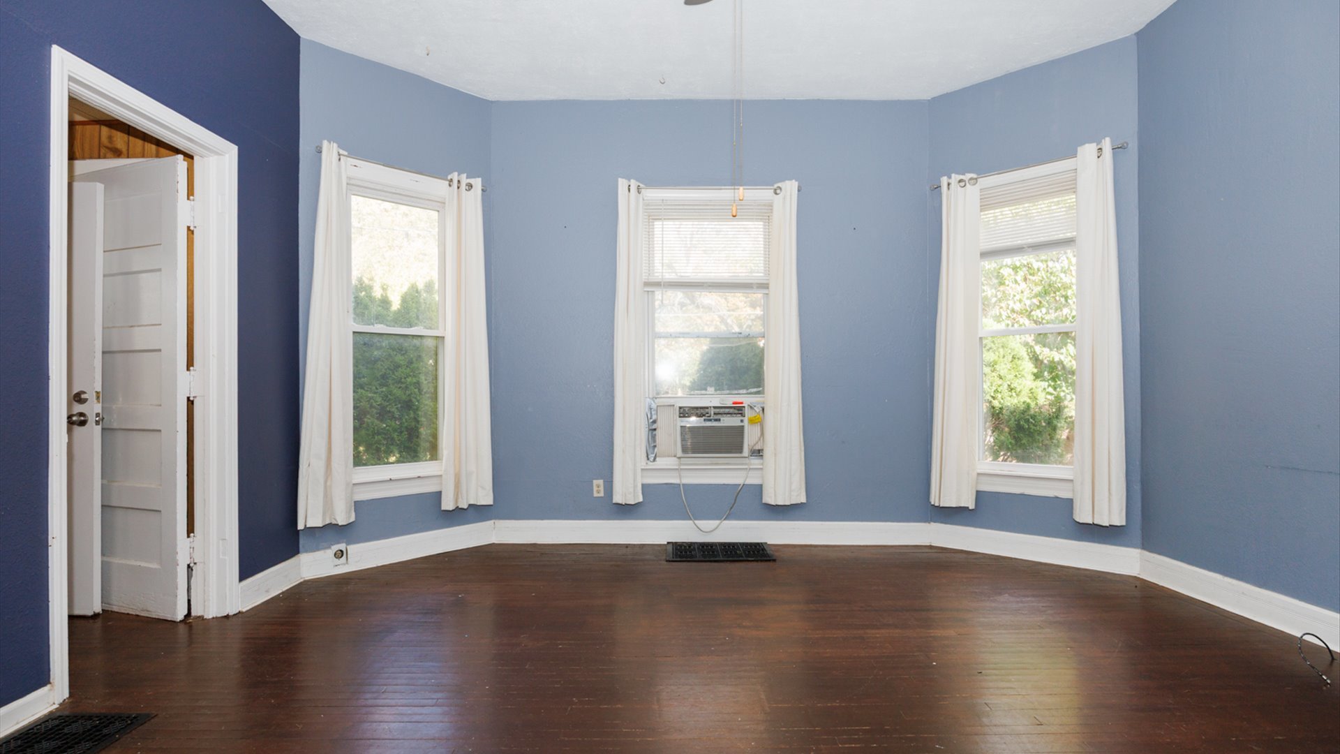 802 South Madison Street Bloomington, IL 61701 - Photo 9 of 33 a view of an empty room with wooden floor and a window