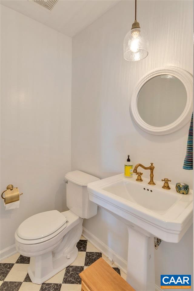 267 Turkey Ridge Road Charlottesville, VA 22903 - Photo 14 of 35 a bathroom with a sink a toilet and a mirror
