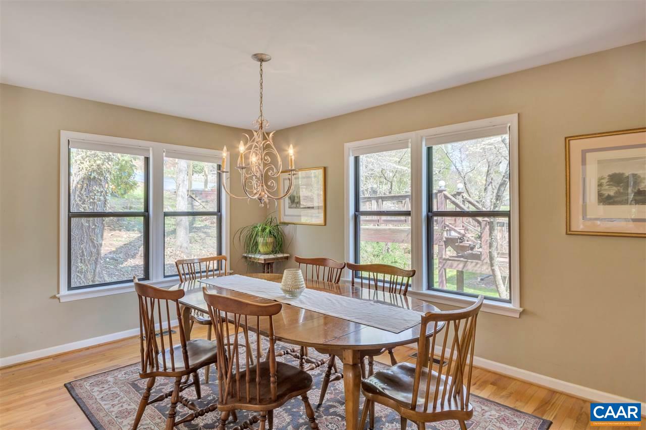 267 Turkey Ridge Road Charlottesville, VA 22903 - Photo 7 of 35 a dining room with furniture a chandelier and wooden floor