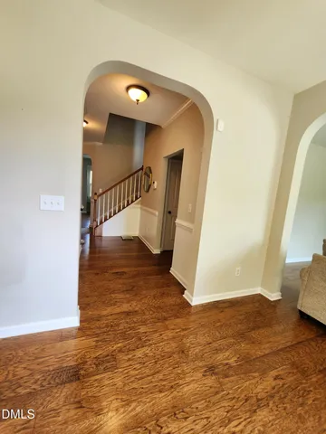 a view of entryway and hall with wooden floor