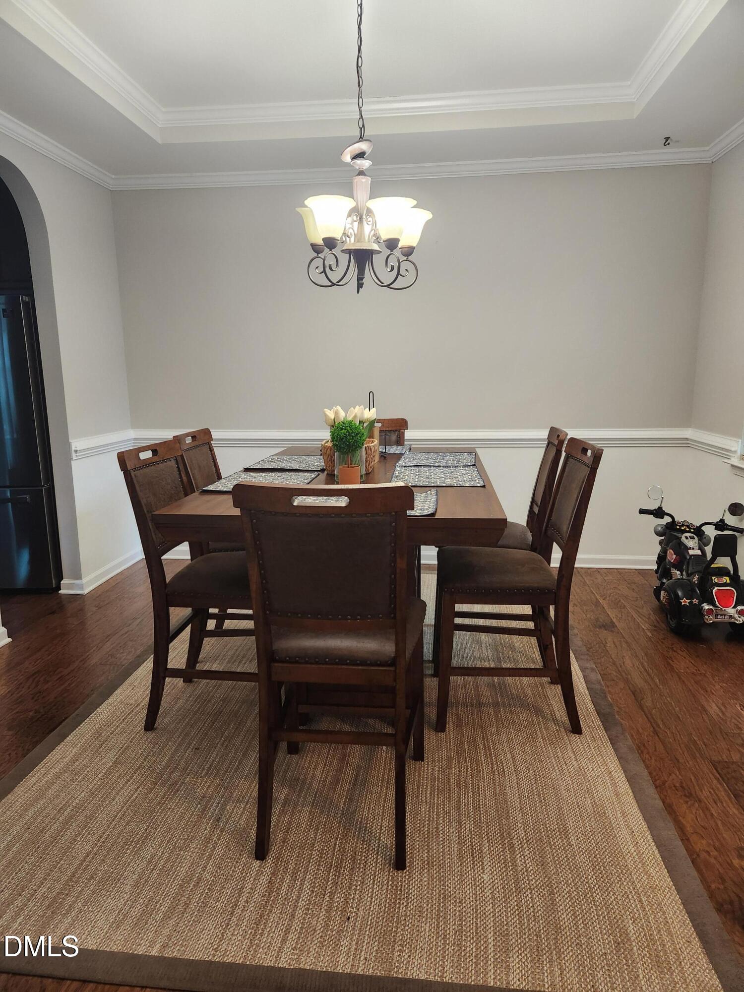 825 Wickham Ridge Road Apex, NC 27539 - Photo 12 of 31 a view of a dining room with furniture and wooden floor