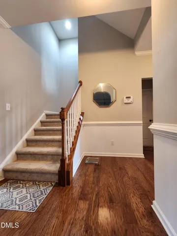 a view of entryway and hall with wooden floor