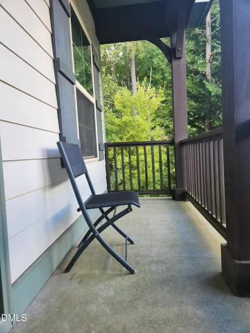 a view of a porch with furniture and a yard